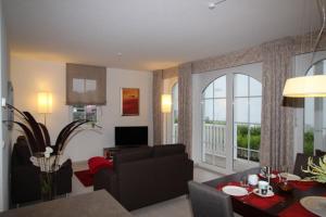 a living room with a couch and a table at Dorothee 1 in Nienhagen