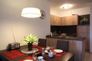 a kitchen and dining room with a table and a dining room at Dorothee 1 in Nienhagen
