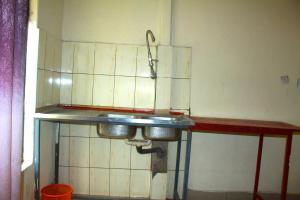 a kitchen with a sink in a room at Fido's Guesthouse in Ruhengeri