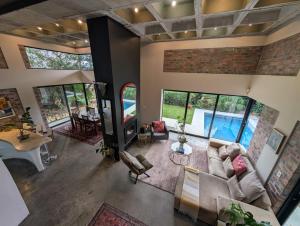 an overhead view of a living room with a brick wall at LA HACIENDA - MODERN, BRIGHT, STYLISH House with Private Pool in Cape Town