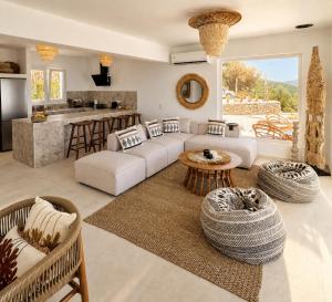 a living room with a couch and a table at Villa Issima Samos, Breathtaking Sea View & Jacuzzi in Samos