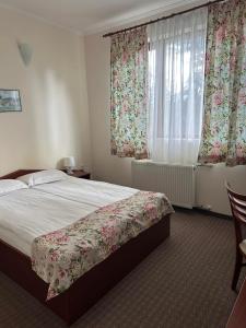 a bedroom with a bed and a window with curtains at Dafovska Hotel in Pamporovo +51 photos