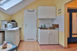 a kitchen with white cabinets and a sink at Herrenhaus Blengow App.18 in Blengow +19 photos