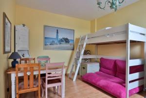 a bedroom with a desk and a bunk bed at Herrenhaus Blengow App.18 in Blengow