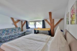 a living room with two beds and a couch at FeWo Hibiskus in Kröpelin