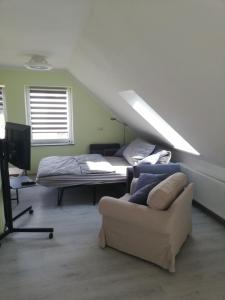 a living room with a bed and a couch at Wittenburg Perdöhl 2 in Wittenburg