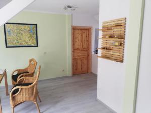 a room with two chairs and a wine rack at Wittenburg Perdöhl 2 in Wittenburg