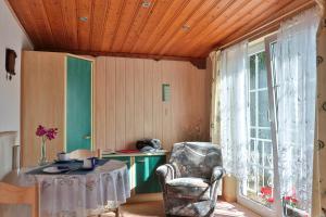 a room with a chair and a table and a window at Waldblick 2 in Kühlungsborn