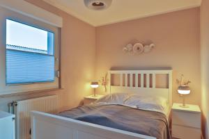 a bedroom with a bed and a large window at Bungalow Paul in Nienhagen