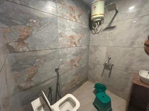 a bathroom with a sink and a toilet in it at Mahendra place in Khātu