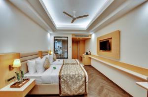 a hotel room with a bed and a tv at Click collection Lucknow in Lucknow