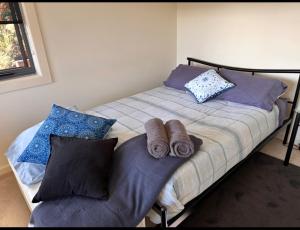 a bedroom with a bed with two towels on it at Executive Accommodation Bairnsdale in Bairnsdale