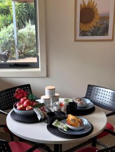 a table with two plates of food on it at Executive Accommodation Bairnsdale in Bairnsdale