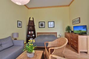 a living room with a bed and a couch at Herrenhaus Blengow App.03 in Blengow