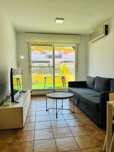 a living room with a couch and a table at Costa Norte in Alcalà de Xivert