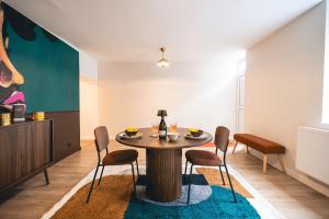 a dining room with a table and chairs at Le Cocopop in Dinant +11 photos