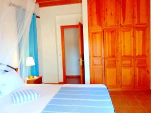 a bedroom with a bed and an open door at Patmos Garden Sea in Grikos