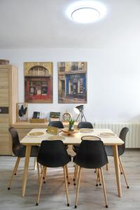a dining room with two tables and chairs at El Racó de la Vero in Falset