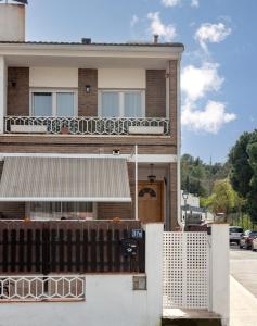 a house with a fence in front of it at El Racó de la Vero in Falset