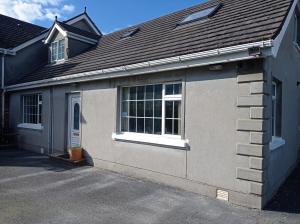 a gray house with a window and a roof at Fjell2Sea in Newcastle