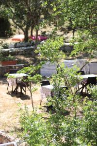 a group of benches and tables in a park at Kalemi Pansiyon in Marmara +54 photos