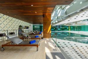 a pool in a building with a swimming pool at LiT BANGKOK Hotel in Bangkok