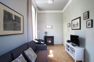 a living room with a couch and a tv at Herrenhaus Blengow App.02 in Blengow +15 photos