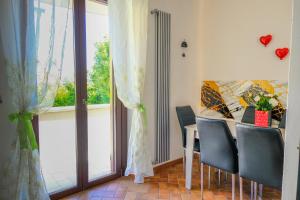 a dining room with a table and chairs and a window at Renée Guest House in Paestum
