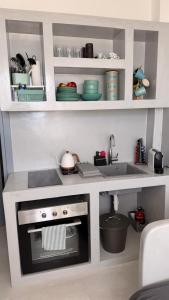 a small kitchen with a stove and a sink at MIRA house in Ios Chora +17 photos