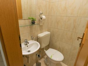 a bathroom with a toilet and a sink at Rondo Condos by TORO in Mostar +44 photos