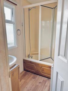 a bathroom with a shower and a sink at 6 Birth Cosy caravan 134 Sealands in Ingoldmells +22 photos