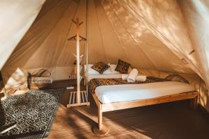 a bedroom with a bed in a tent at Habitat Eco Farm in Sorrento