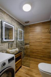 a bathroom with a shower and a sink and a washing machine at Sarakina Urban Grace in Stone by 8essentially in Heraklio +41 photos