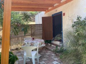 a table and a chair on a patio at Kalemi Pansiyon in Marmara