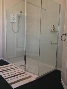 a shower with a glass enclosure in a bathroom at The Waterford in Blackpool