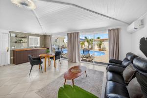 a living room with a couch and a table at Spacious Villa Victoria Heated Pool in Callao Salvaje