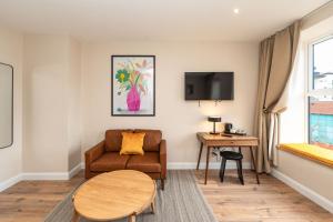 a living room with a couch and a table at Wee Sleep Ireland in Derry Londonderry