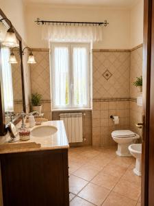 a bathroom with a sink and a toilet at Holiday House Nemi in Monte Porzio +28 photos