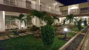 a courtyard of an apartment building at night at Hotel Ella Tambolaka in Tambolaka Airport