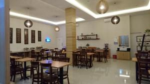 a restaurant with tables and chairs in a room at Hotel Ella Tambolaka in Tambolaka Airport