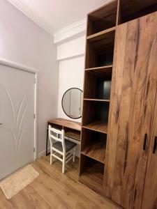 a room with a desk and a mirror at Gwin Hotel in Fier