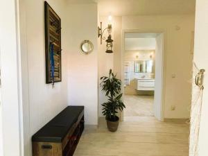 a living room with a black bench and a plant at Ferienhaus "Christin" Objekt-ID 15689-2 in Waren