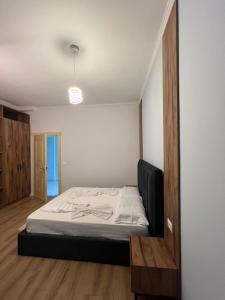 a bedroom with a bed and a television in it at Gwin Hotel in Fier