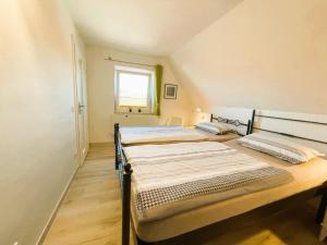 two twin beds in a room with a window at Ferienhaus "Christin" Objekt-ID 15689-2 in Waren