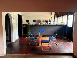 a room with two chairs and a table and a counter at Bed Station Negombo in Negombo