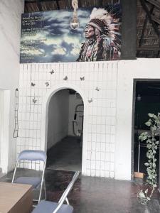 a wall with an arch with a painting of a soldier at Bed Station Negombo in Negombo
