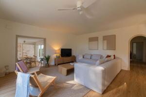 a living room with a couch and a table at Villa Can Ferrer in the centre of Cala dOr in Cacla D'or