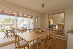 a dining room with a wooden table and chairs at Villa Can Ferrer in the centre of Cala dOr in Cacla D'or
