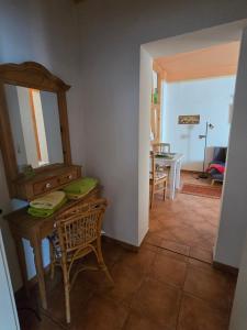 a living room with a table and a mirror at Pension Reuss - Hotel garni in Erfurt +27 photos