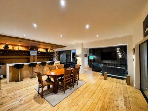 a living room with a table and chairs and a bar at Harties Lake View in Hartbeespoort